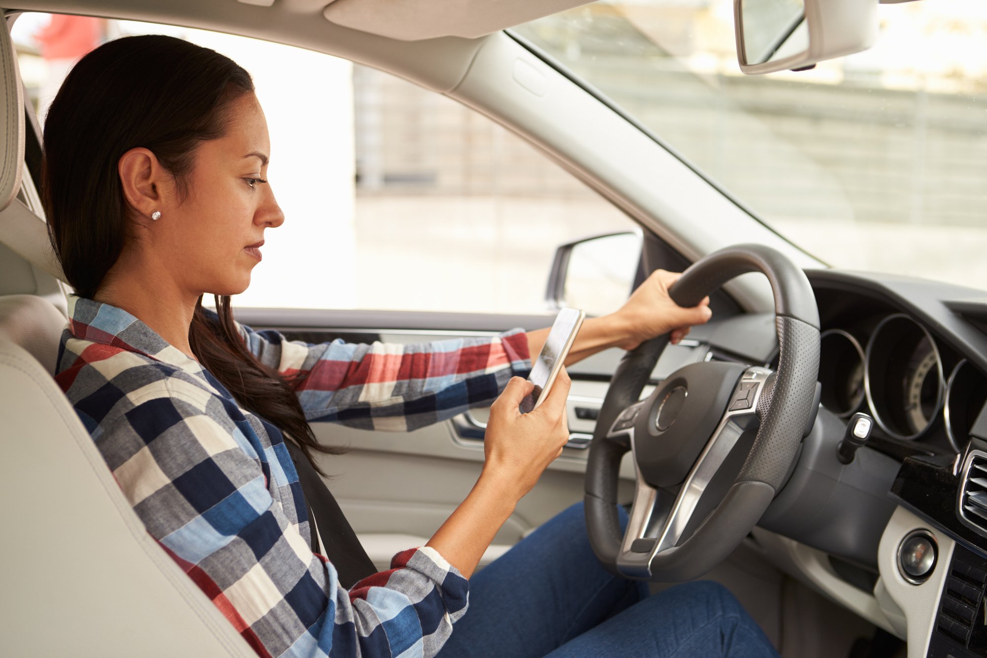 Woman texting and driving.