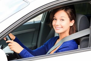 Young woman sitting in driver seat of car
