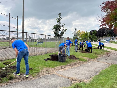 West Bend associates plant trees at Bryant Playfield in Milwaukee. 