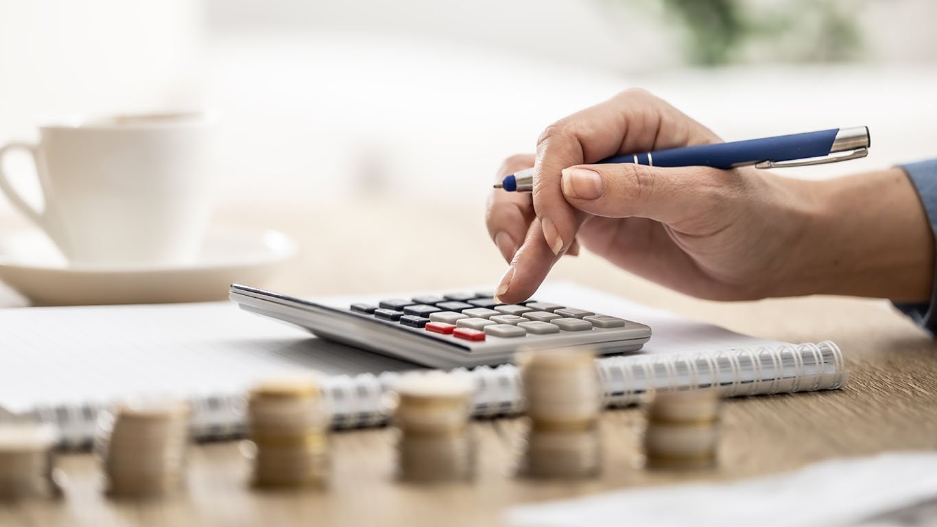 hands-counting-coins-and-making-notes