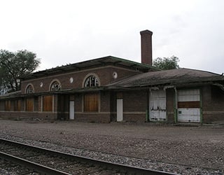 vacant building by railroad track