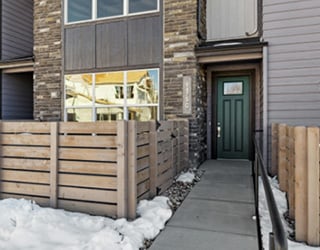 outdoor sidewalk leading into apartment building with snow on the ground