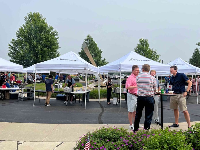 Associates hanging out and talking on the patio at West Bend.