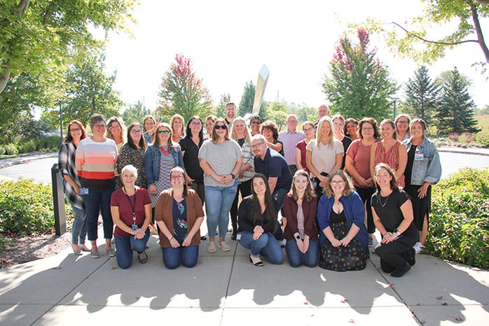 Customer Care team gathered outside for group photo.