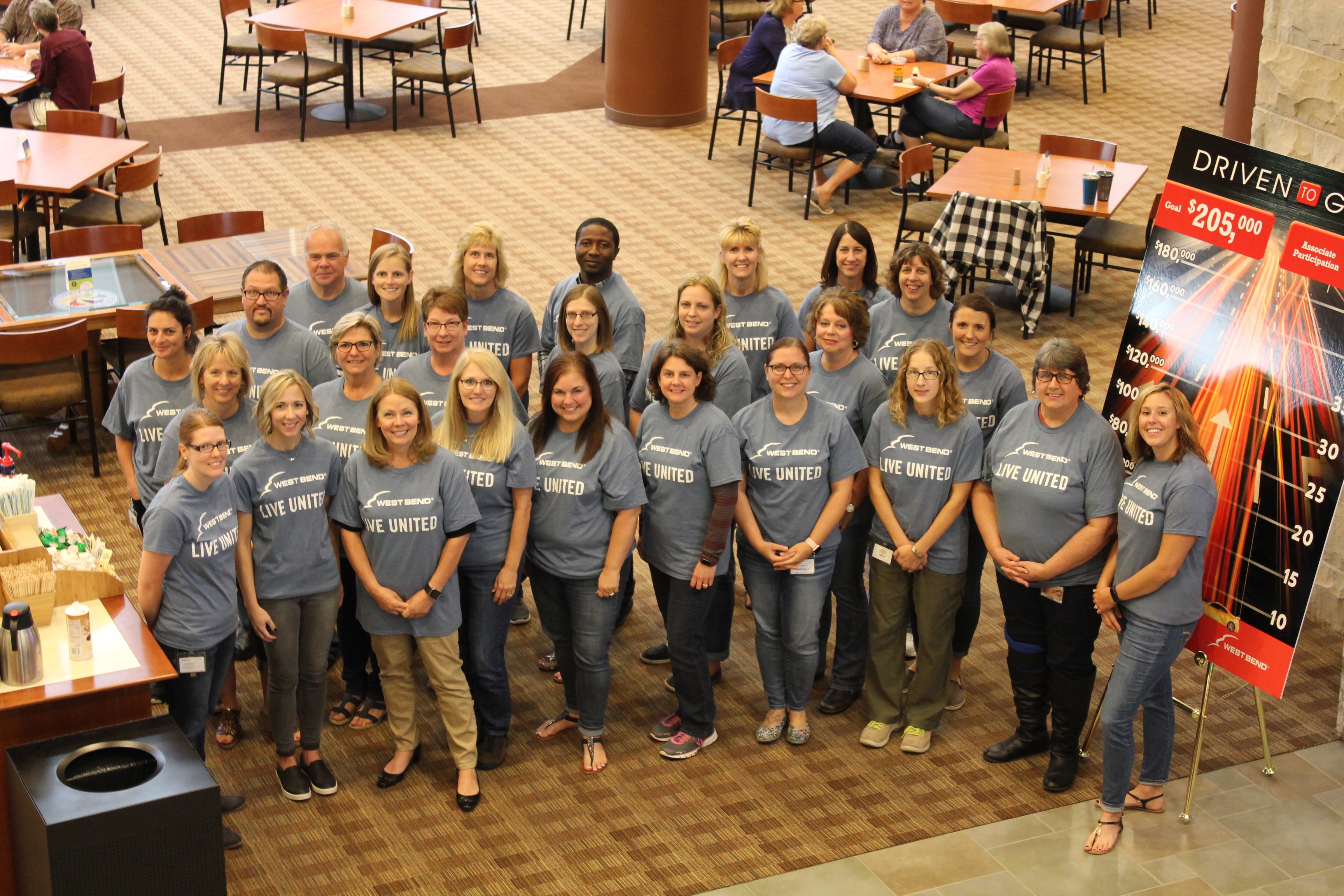 Group photo of West Bend associates wearing Live United T-shirts.