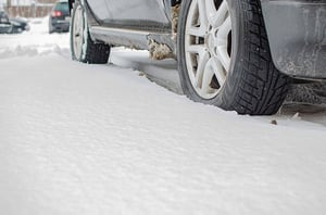 car tires driving through winter snow