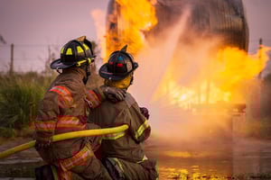 fire fighters putting fire out at house