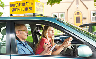 driving instructor and student driver go for test drive