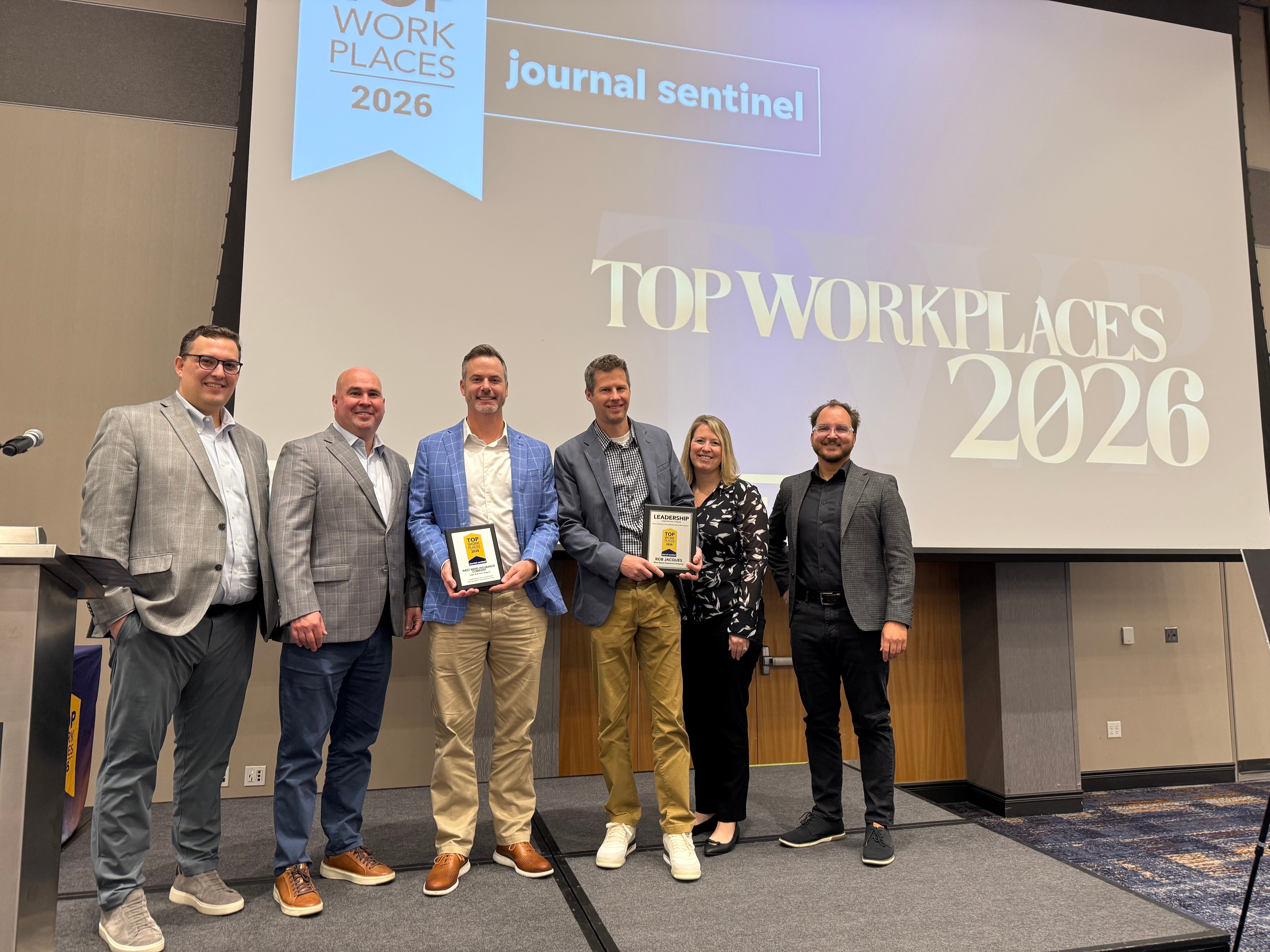 Associates from West Bend being recognized for award. 