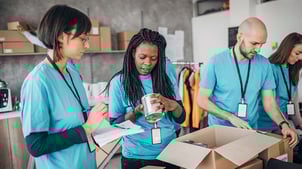 volunteers packing donation boxes for charity food bank