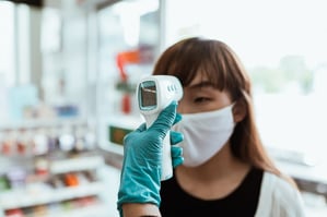 woman-wearing-a-face-mask-getting-her-temperature-checked-4429561