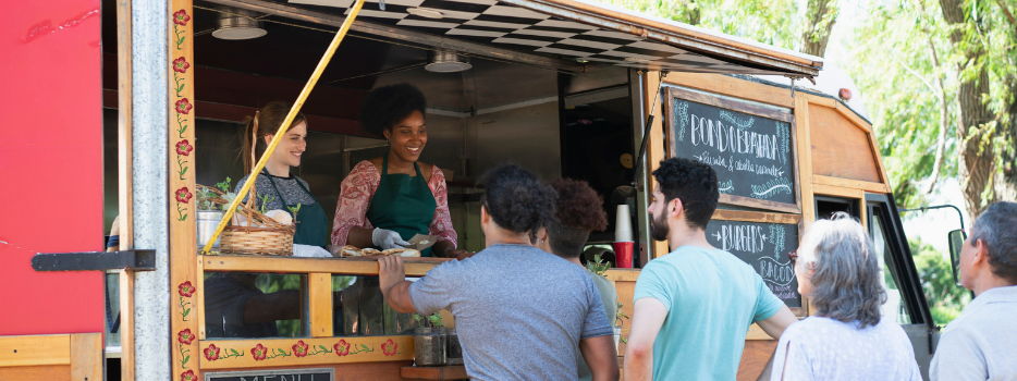 A group of people ordering food from a food truck