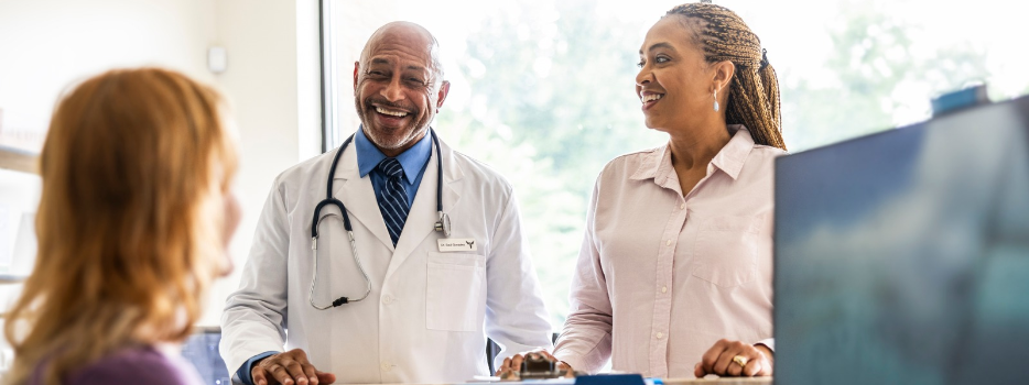 A doctor and patient at a reception desk