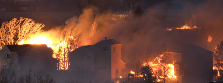 A wildfire burning houses